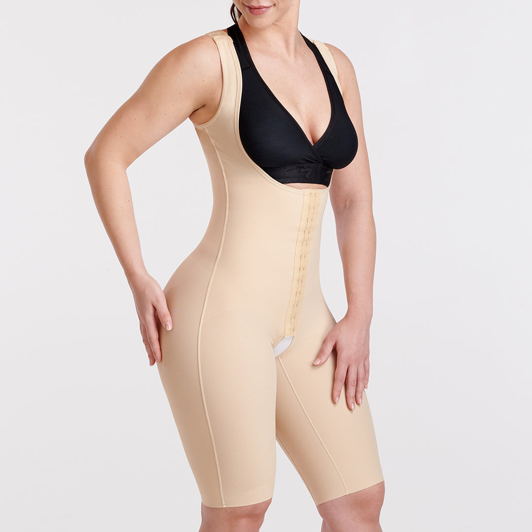 Woman wearing a beige short-length, open-bust compression bodysuit for post-surgical recovery.