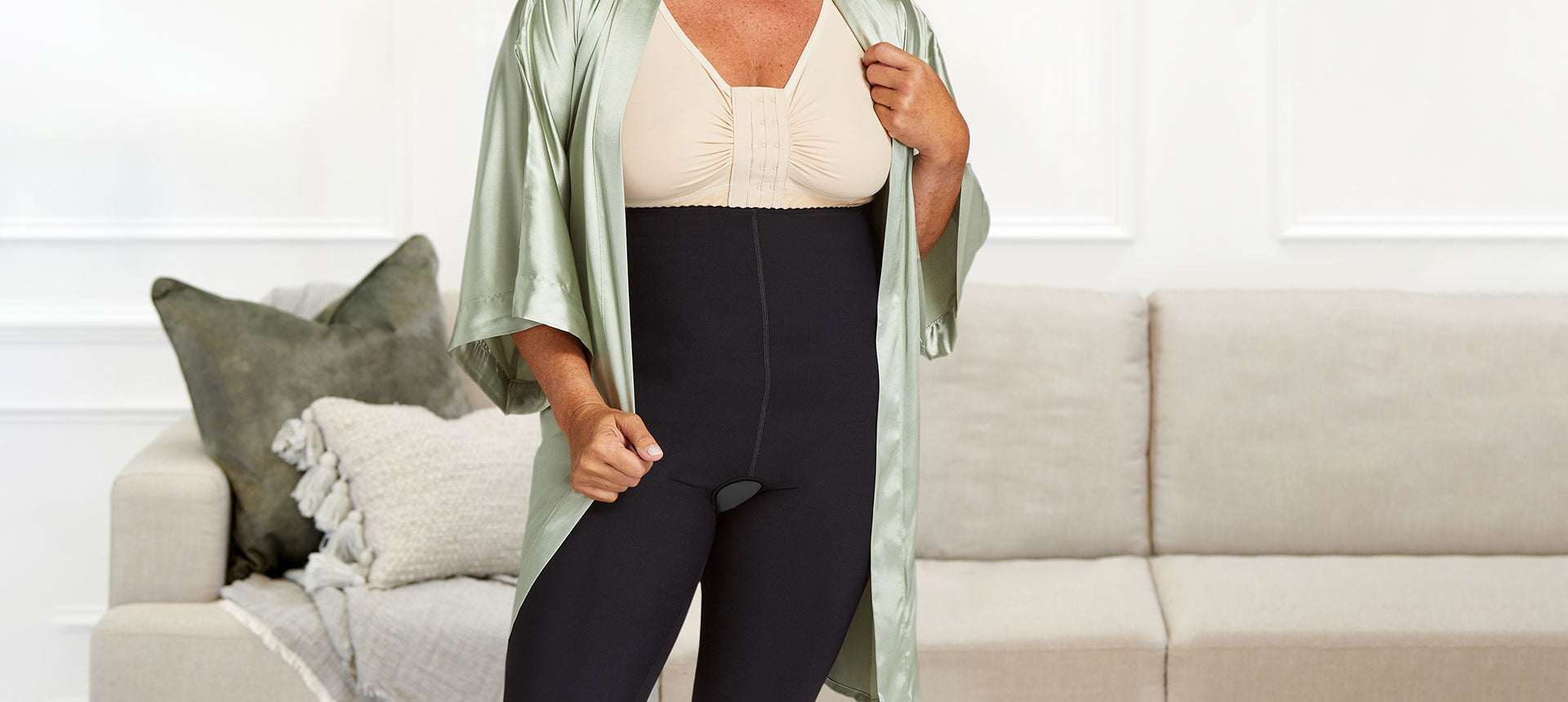 A woman poses comfortably in a lipedema compression garment.