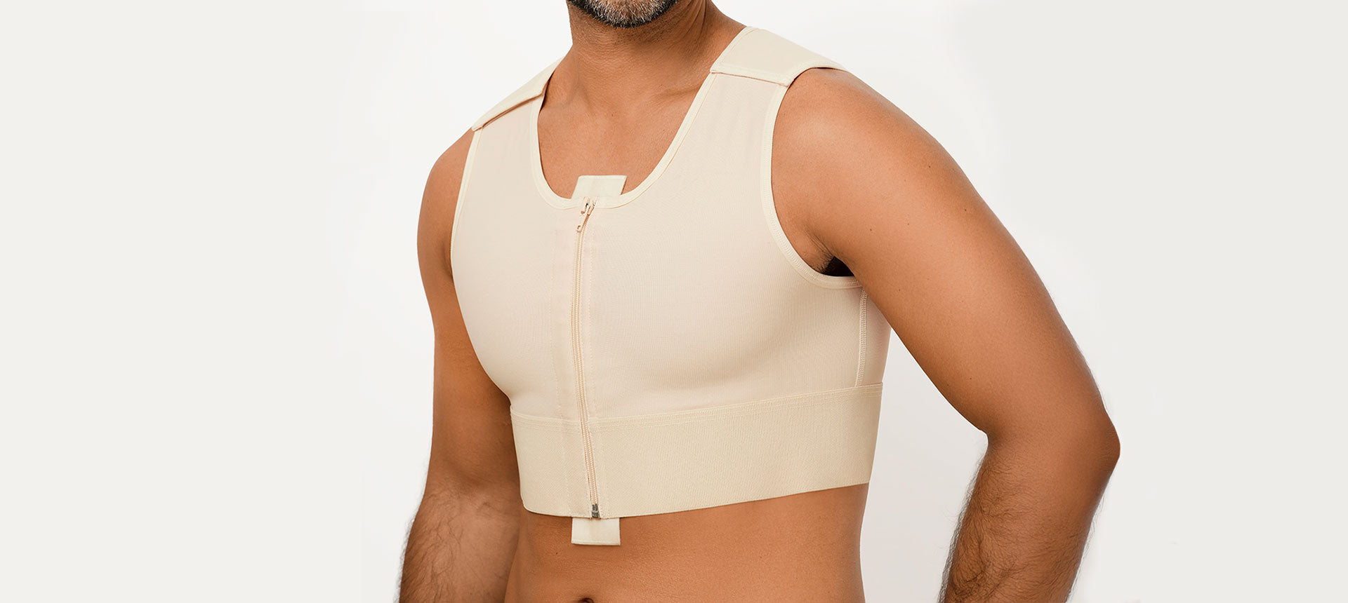 A close-up picture of a man wearing a comfortable, post-surgical compression vest. The vest is sleeveless and has a zipper front closure.