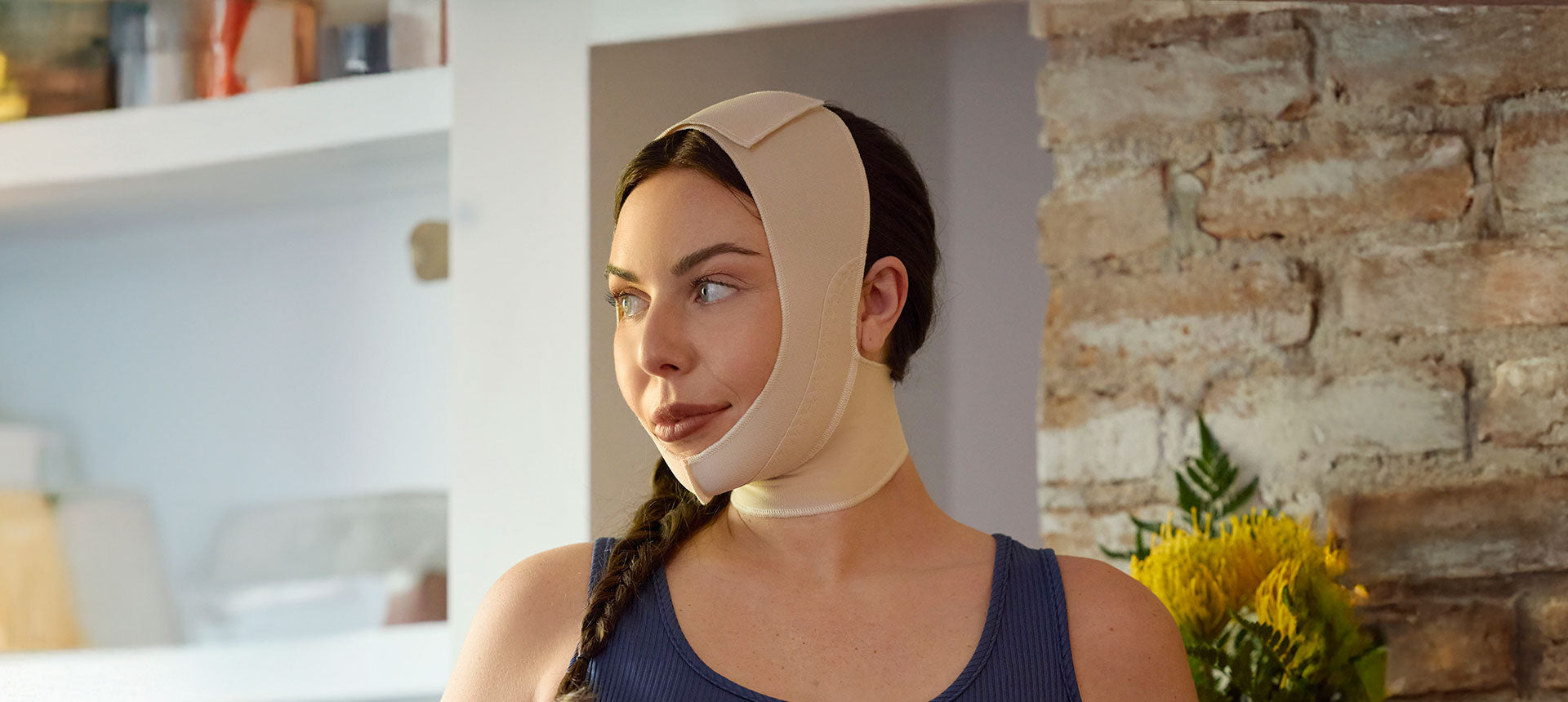Woman wearing a post-surgical compression face mask.