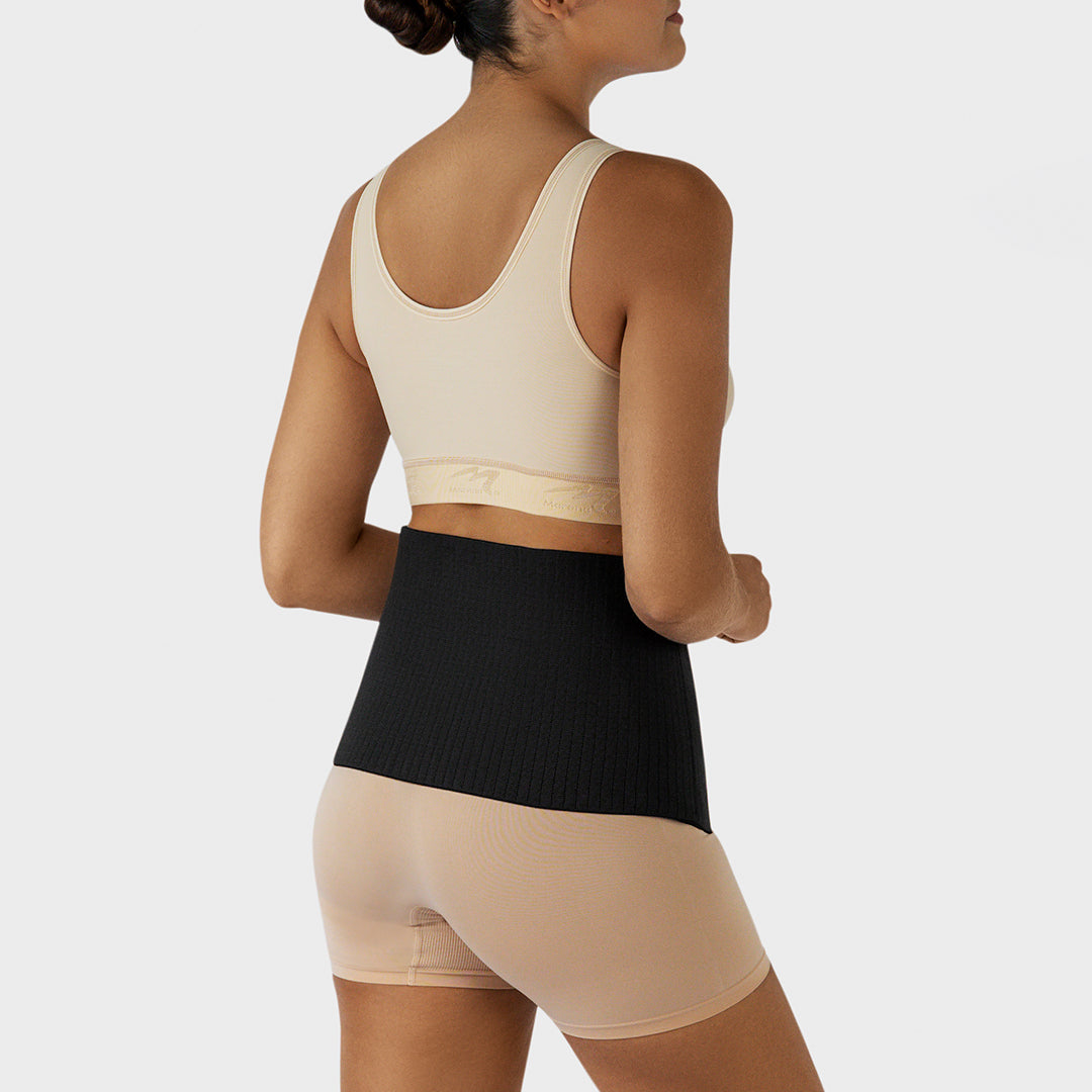 Marena Recovery style AICAB09 abdominal binder back view, shown in black on female model.