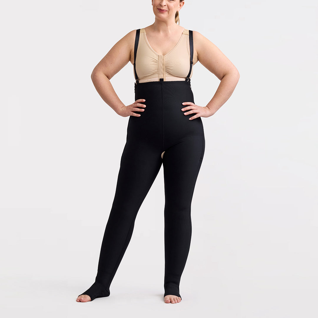 Marena Recovery style LIPSGSZ, Lipedema Post-Surgical Girdle with side zipper closures and suspenders in black, shown from the front on a female model.