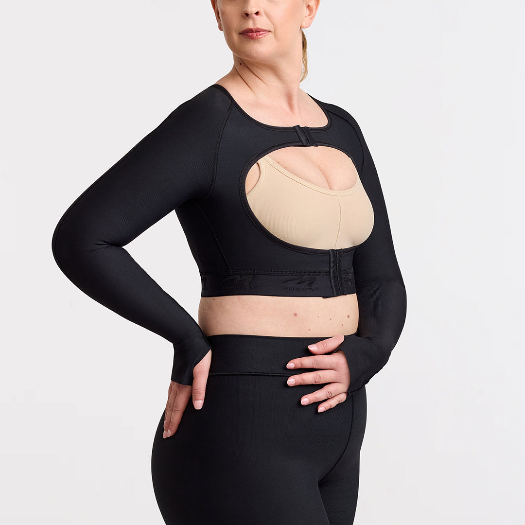 Marena Recovery style LIVOLH Lipedema Post-Surgical Open Bust Vest With Hand Coverage, in black, side view shown on a female model.