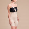 Marena Recovery style FBT compression girdle with suspenders thigh length, side view with crossing straps in beige