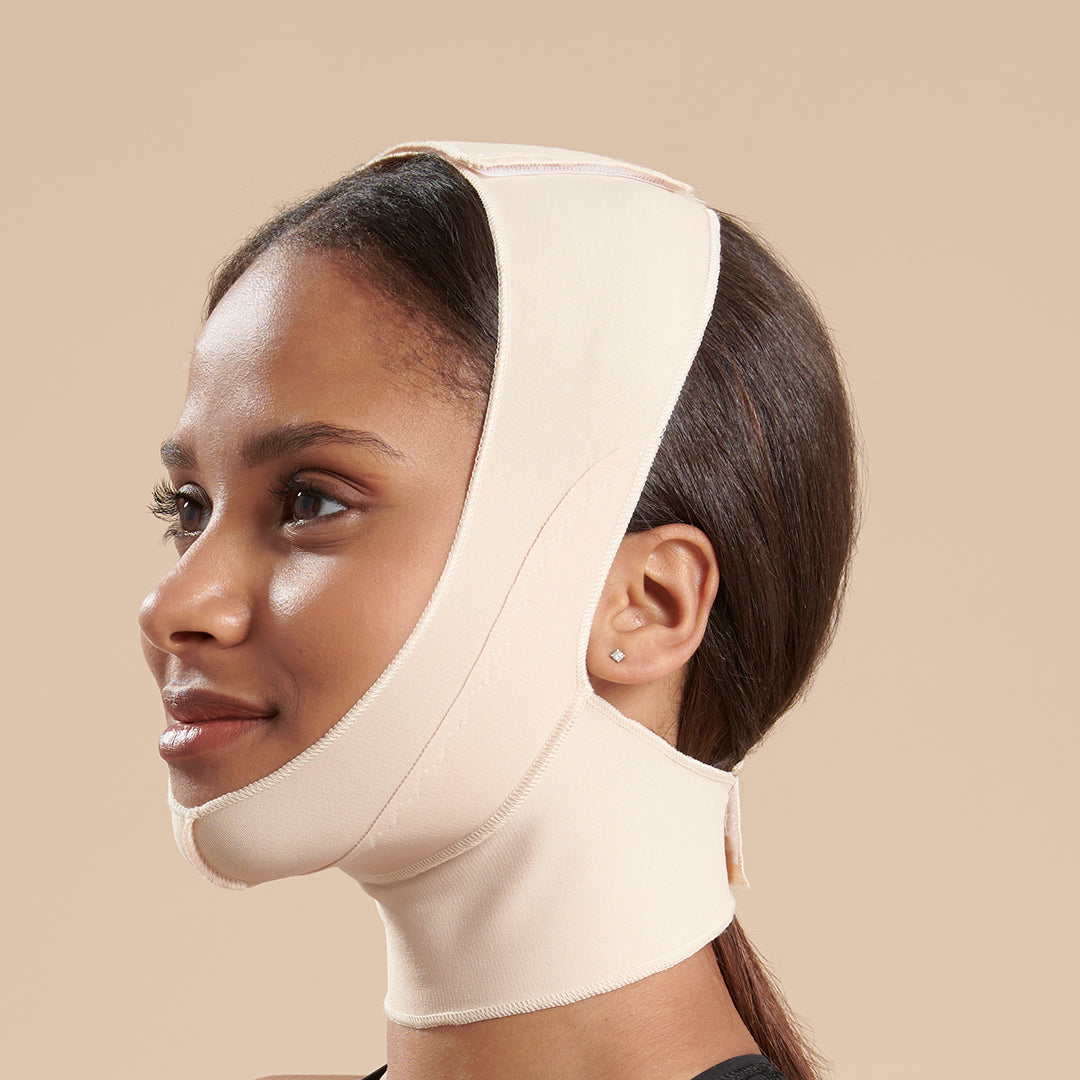Marena Recovery style FM100-B minimal coverage, mid neck length compression face mask, side view in beige shown on female model.